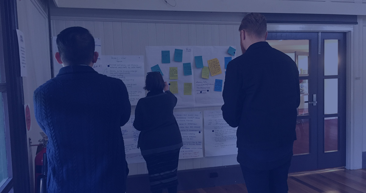 Header image showing workshop attendees providing feedback