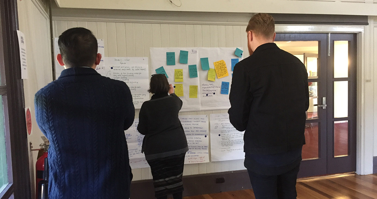 Header image showing workshop attendees providing feedback