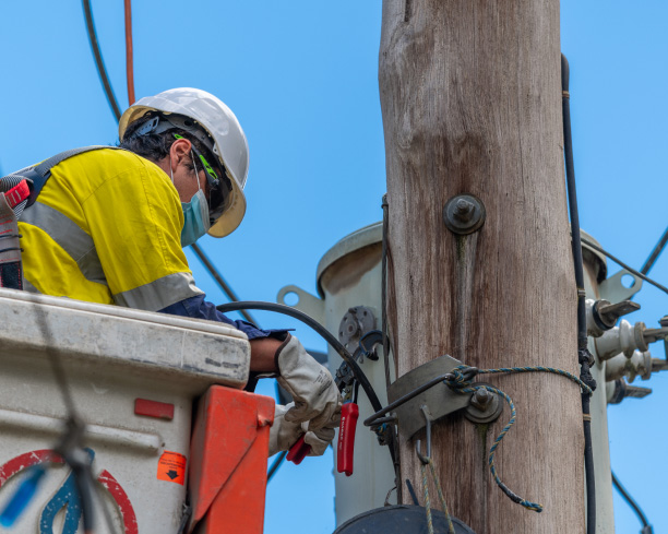 Image of line worker on power pole